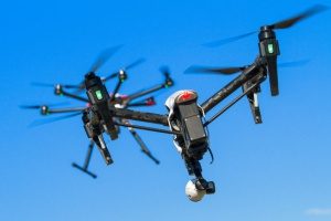 two adjacent drones with hull coverage insurance capturing high quality video