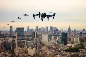 pictures of a drone in multiple positions flying over New York City with proper aviation and premises liability coverage in case it were to crash