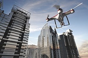 UAV equipped with drone insurance flying through highrise buildings in order to capture city life for an upcoming documentary